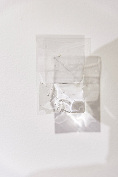 Close detail of a transparent water-filled element casting light and shadow