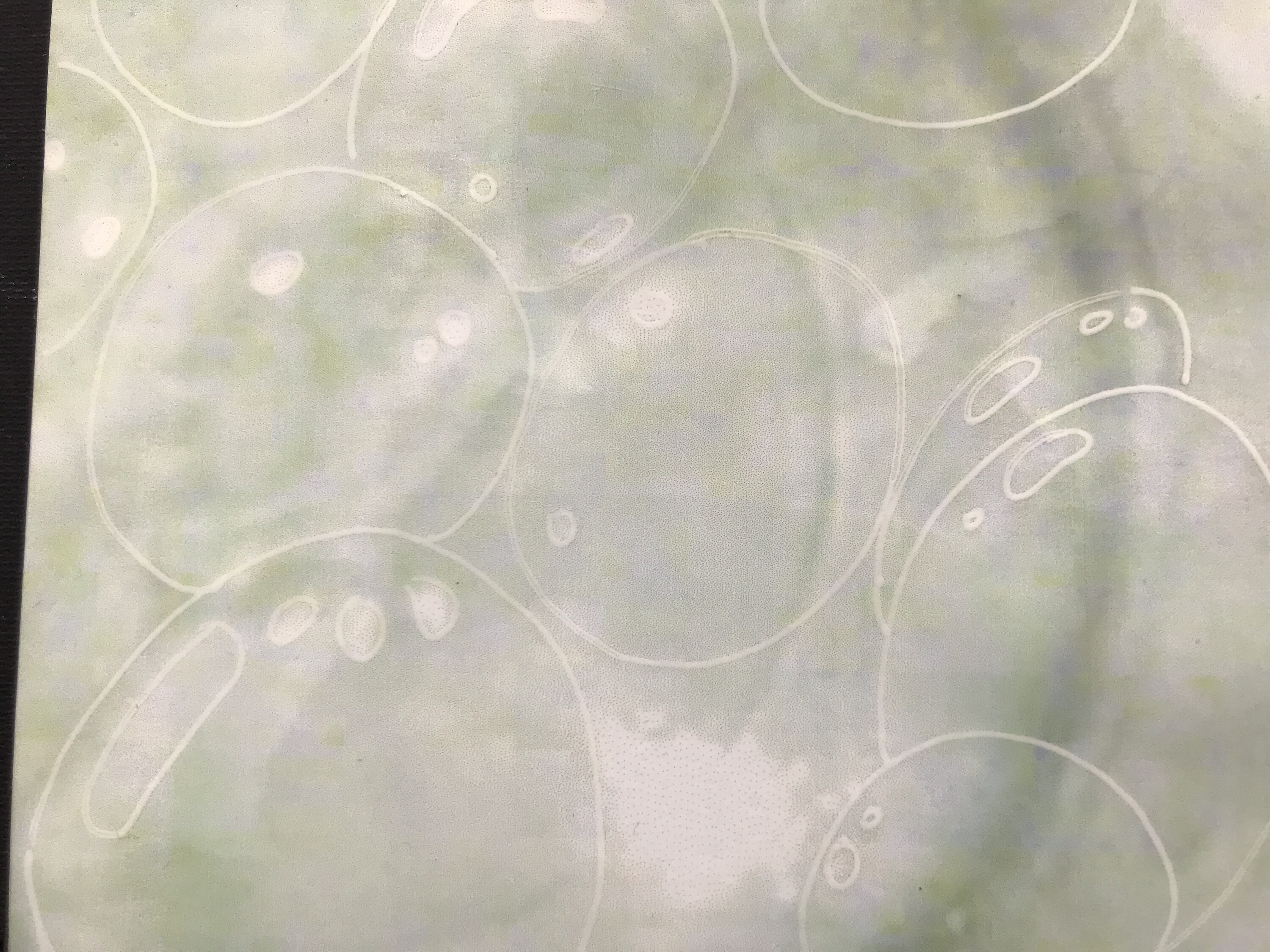 Layered translucent circular forms in a mixed-media work